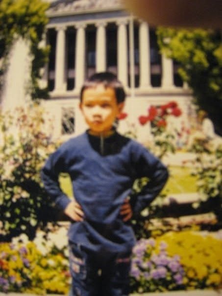 A boy smiling in a childhood photo